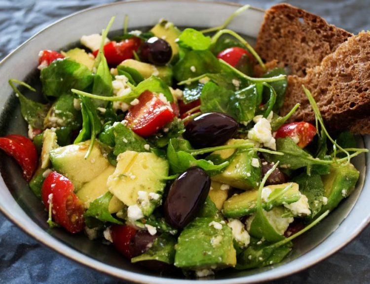 Delicious Greek salad featuring avocado, feta, and olives, ideal for a healthy meal.