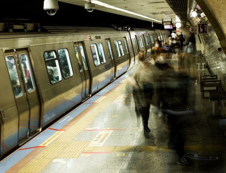 Long exposure shot of commuters at a bustling Istanbul subway station.