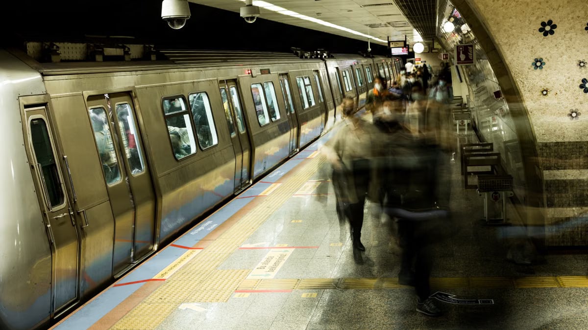 Long exposure shot of commuters at a bustling Istanbul subway station.